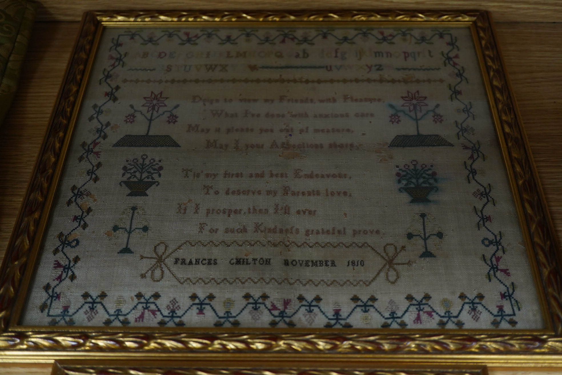 Three framed and glazed samplers, including a 1740 banded sampler by Mary Jelson, 20.5cm x 24cm, embroidered with three various verses, together with a later, smaller, alphabet sampler dated 1760, 15cm x 14cm and another